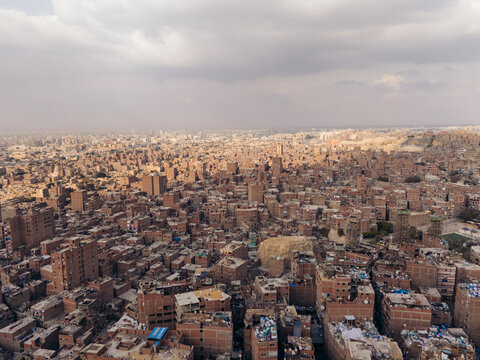 Aerial view of the dense urban landscape of Mansheya Nasir, also known as The Garbage City, with crowded residential buildings and a sprawling skyline, Cairo, Egypt.