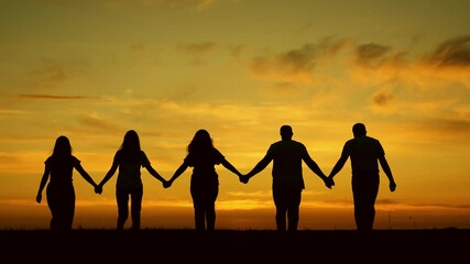 Unity of group of people united by team idea. Team of people look at their future together at sunset, park. Human resources. Group of business person outdoor. Community of people joint prayer, sunset