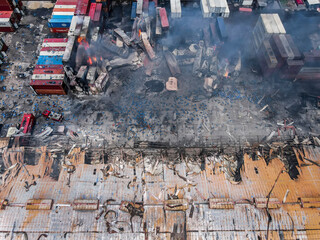 Sitakunda, Bangladesh - 05 June 2022: Aerial view of fire and smoke rising from a damaged container depot with burnt containers and debris, Sitakunda, Bangladesh.