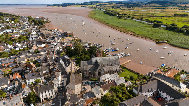 Aerial view of the picturesque River Exe with charming boats and the historic Saint Margaret, Topsham, England.