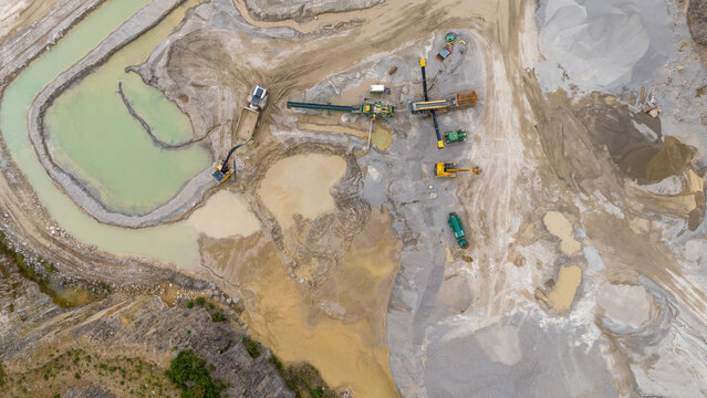 Aerial view of an industrial construction site with excavators and machinery in a quarry, St Ann's Chapel, Gunnislake, England.