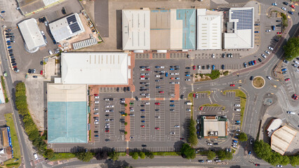 Aerial view of a busy retail park with organized parking lots and modern buildings, Bridgwater, United Kingdom.