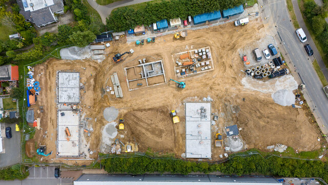 Aerial view of new residential construction site with buildings and equipment, Bude, United Kingdom.
