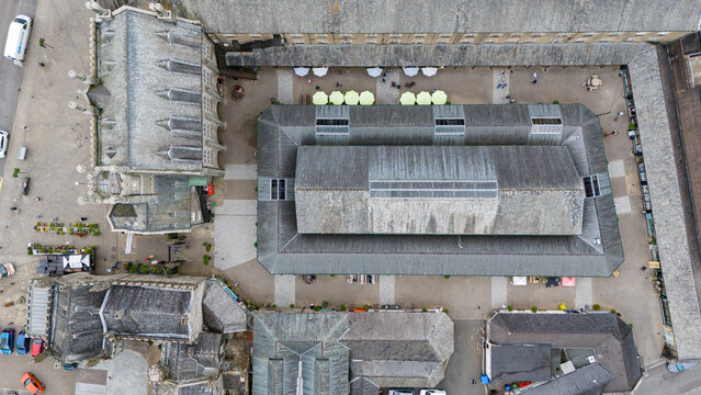 Aerial view of the bustling pannier market surrounded by historic architecture and quaint rooftops, Tavistock, England.