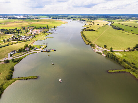 Aerial view of river Nederrijn with groynes and crossing ferry between Eck en Wiel and Amerongen, border between provinces of Gelderland and Utrecht, Netherlands.