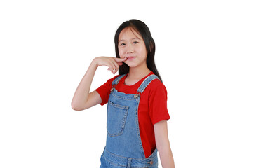 Portrait of smiling Asian girl kid hold finger at mouth while standing and looking at you isolated on white studio background.