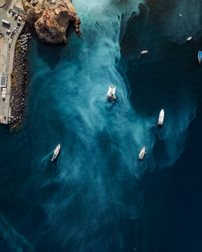 Aerial view of Vulcano Port on Vulcano island with sulfur water along the coast with boats, Aeolian Islands archipelagos, Sicily, Italy.