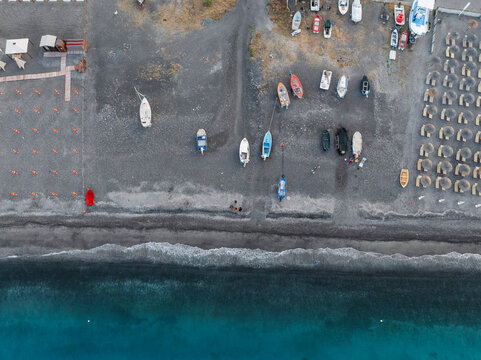 Aerial view of boats along the coastline in Canneto small town along the Mediterranean coastline, Lipari, Aeolian Islands archipelagos, Sicily, Italy.