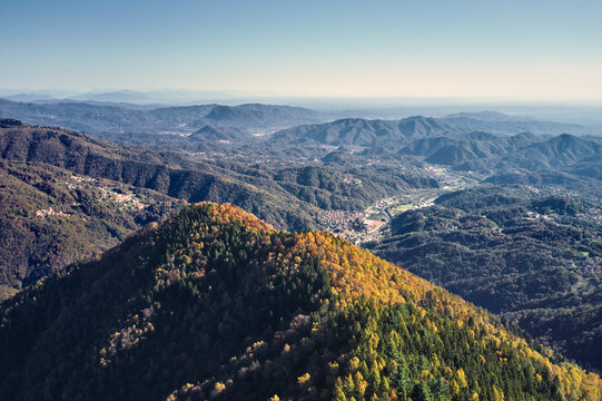 Aerial view of many colorful trees on the hills in Trivero, Piedmont, Italy.