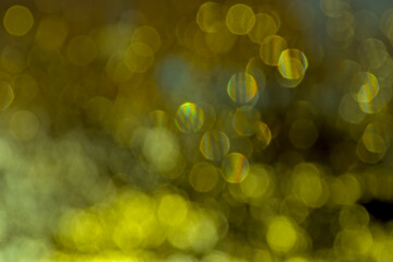 Abstract background blur with bokeh light circles in tints of yellow 