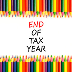 End of tax year symbol. Concept words phrase End of tax year on beautiful white paper. Colored pencils. Beautiful white paper background. Business End of tax year concept. Copy space.