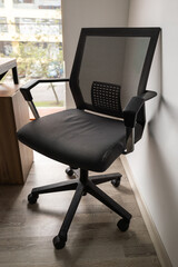 A modern black office chair with an ergonomic design, offering comfort and style for professional workspaces and home offices.

