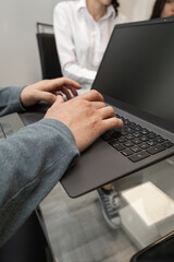 A focused boss writes on a tablet during work, highlighting modern technology, productivity, and professional organization in a business environment.

