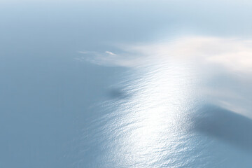Obraz premium aerial view of serene and tranquil ocean surface showcasing gentle waves and soft reflections of sky