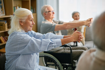 Seniors engaging in a group exercise session in a community center Elderly participants enjoying...