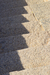 Abstract patterned steps architecturally crafted and constructed in the rocks in mahabalipuram, with the morning shadows covering in zig-zag manner on the steps