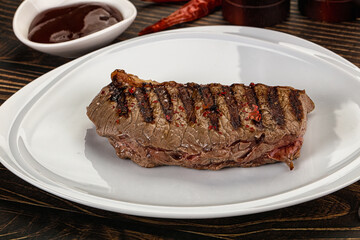 Grilled beef striploin steak with sauce