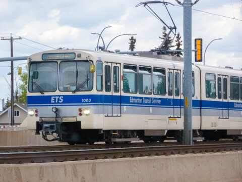Edmonton, Alberta, Canada. May 21, 2025. An Edmonton LRT train, emblazoned with "ETS," glides along its tracks, a vital artery of the city's public transportation network.