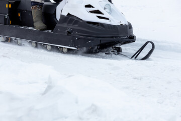 A snowmobile is on a snowy surface