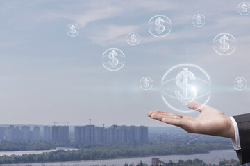 Hand presenting dollar coins over Cityscape