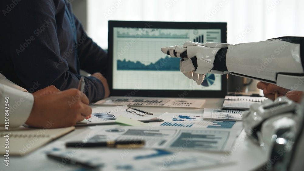 Poster a modern workspace featuring a robot hand pointing at data analysis charts during a professional mee