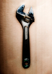 adjustable wrench on a metal background