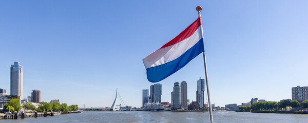 Panoramic view with Dutch flag from cruise ship of Erasmus bridge and Kop van Zuid peninsula in Rotterdam The Netherlands