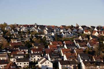 Densely built German mountain town seen from above, featuring traditional red tiled roofs and charming alpine architecture nestled in the hills.