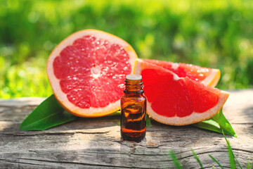 grapefruit essential oil in a bottle. Selective focus.