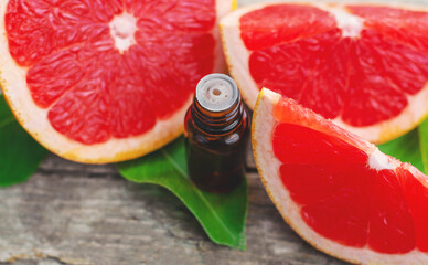 grapefruit essential oil in a bottle. Selective focus.