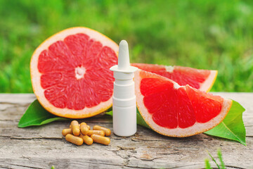 grapefruit essential oil in a bottle. Selective focus.