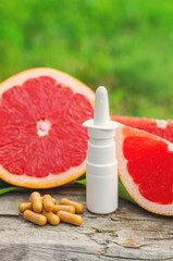 grapefruit essential oil in a bottle. Selective focus.