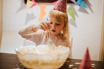 Sibling celebration with cake preparation at a home birthday party