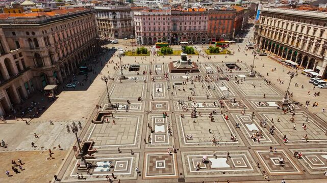 Bustling life in Piazza del Duomo in Milan, Lombardy, Italy surrounded by grand cathedral facade
