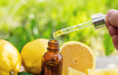 lemon essential oil in a bottle. Selective focus.