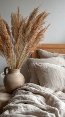 Cozy bedroom with natural decor featuring dried pampas grass in vase