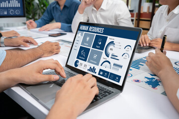 Human resources management software on computer screen helping human resources employee to manage...