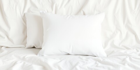 Obraz premium Two white pillows resting on a white crumpled sheet creating a minimalist and clean aesthetic scene