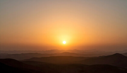 Desert Sunset Landscape: Orange and Yellow Hues Over Rolling Hills
