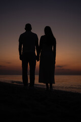 silhouette of a man and a woman at dawn