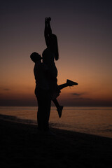silhouette of a man and a woman at dawn