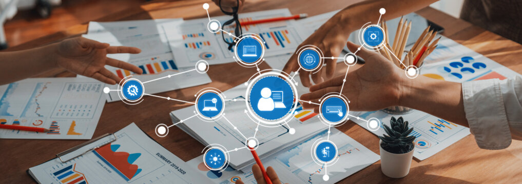 Analyst team utilizing BI Fintech to analyze and pointing at financial dashboard paper office. Businesspeople examining report paper on table for business insight. Panorama shot. Scrutinize Amity