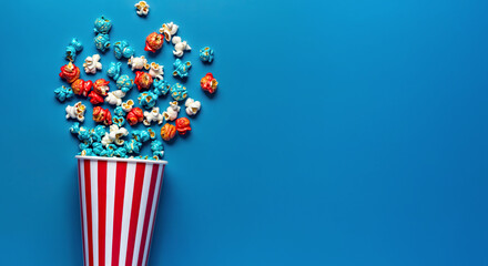 Top Down View of  Popcorn Colored in Red White and Blue Colors Scattered on Empty Clean Surface With Copy Space