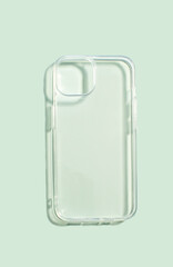 Transparent smartphone case mock up on a soft green background, showcasing minimalist design and...
