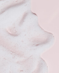 Soft cleansing foam and bubbles on pink background. Ideal for skincare, spa, cosmetic product backgrounds, or wellness-themed visuals.