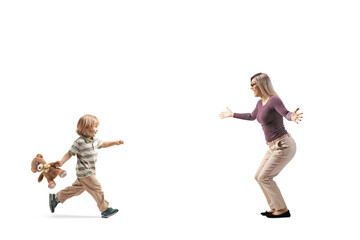 Boy with a teddy bear running to hug his mother