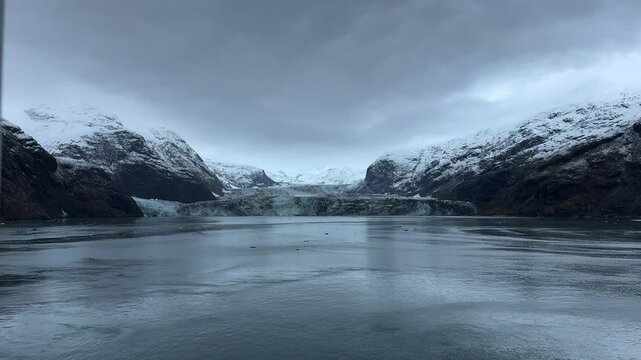 13 October 2024 - USA, Alaska, Glacier Bay National Park and Preserve, Johns Hopkins Inlet - panorama view from cruise ship slowly turning in front of massive claving tidewater glaciers