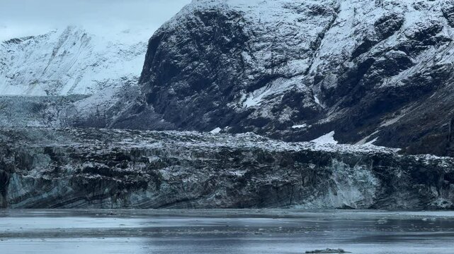 13 October 2024 - USA, Alaska, Glacier Bay National Park and Preserve, Johns Hopkins Inlet - cruise ship slowly turning in front of massive claving tidewater glaciers of the Fairweather Range