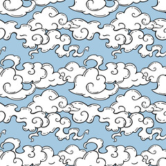Chinese clouds seamless pattern. Vector illustration of swirling cartoon clouds on a blue sky. Hand-drawn doodle style. Background element for textiles, wallpapers, and packaging