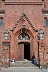 Portal of a neo-Gothic brick church in the city of Lubniewice